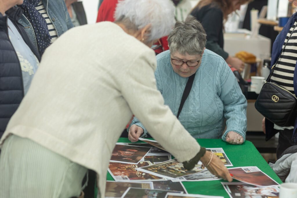 Women looking at photos and swapping stories
