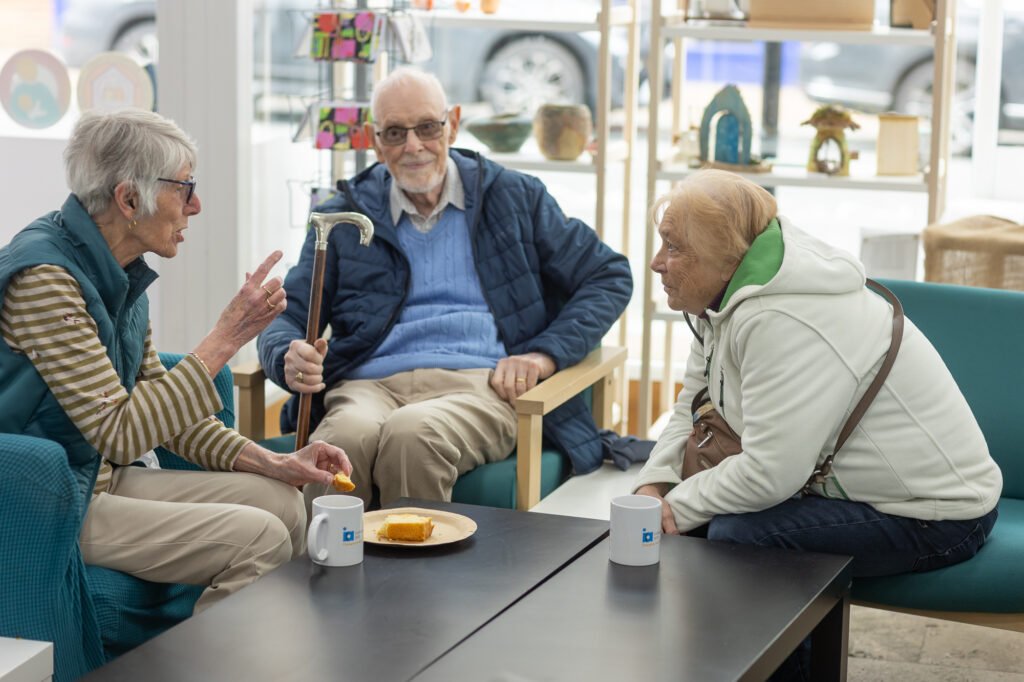 Two Women and a man swapping stories