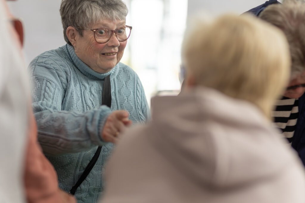 Women looking at photos and swapping stories