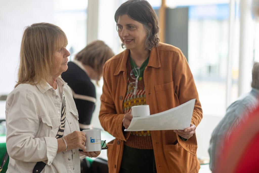 Women looking at photos and swapping stories