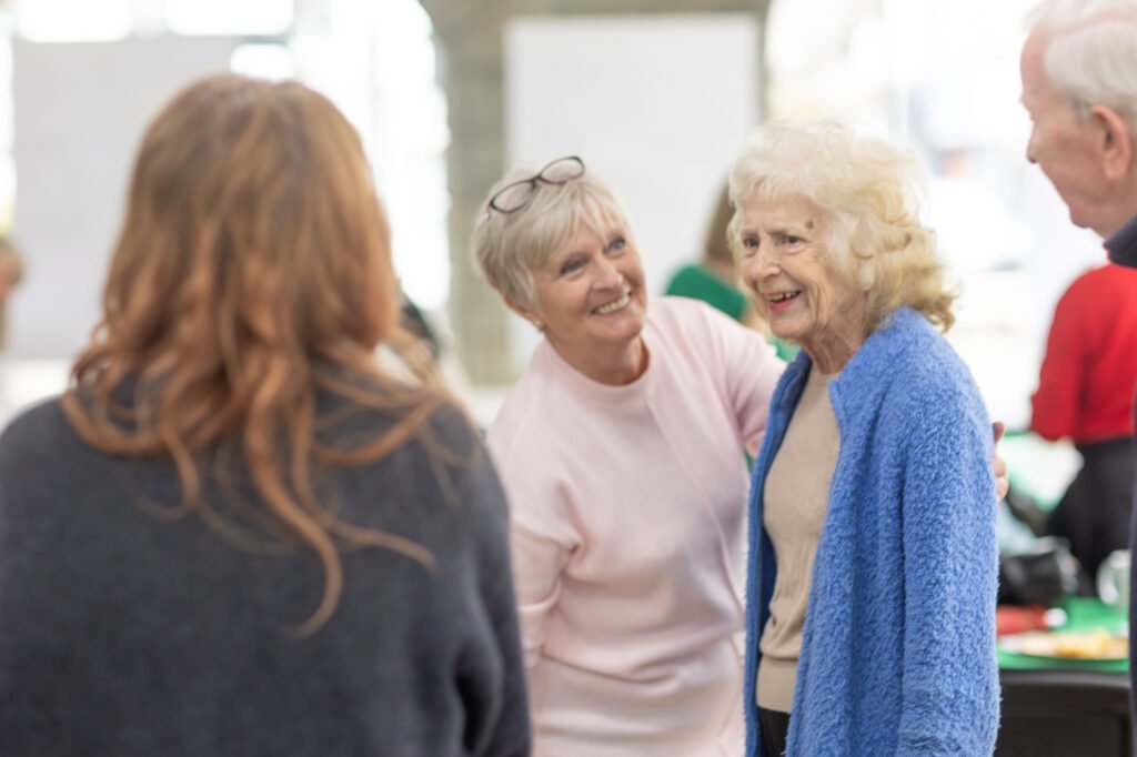 Women looking at photos and swapping stories