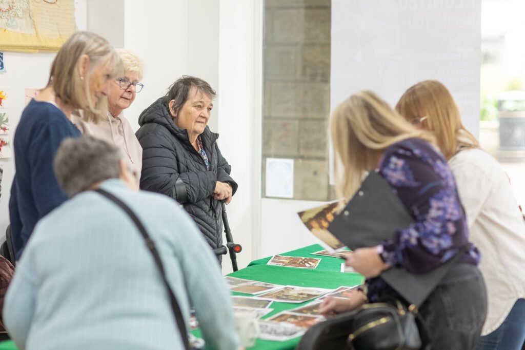 Women looking at photos and swapping stories
