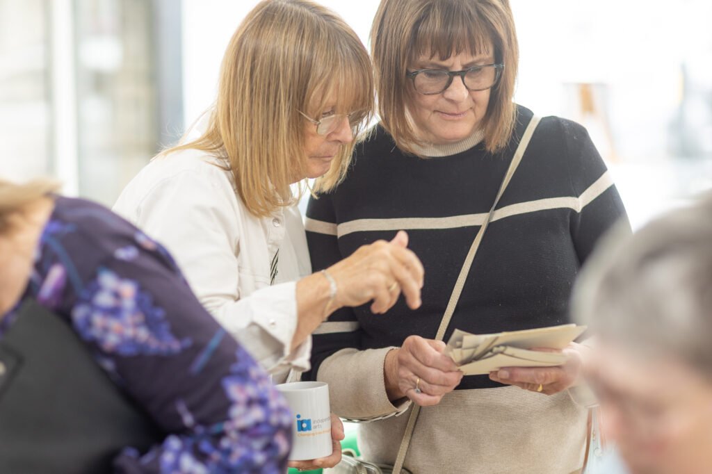 Women looking at photos and swapping stories