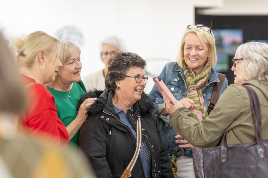 Happy group share photos at Ronson's Reunited