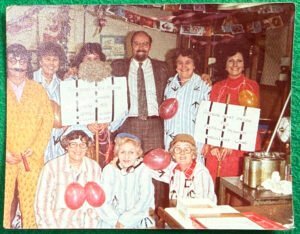 Colour photograph of Ronson ancillary staff in striped prisoner costumes, holding signs reading 'Ronsons Open Prison' and 'Ronsons Inert Prison'.